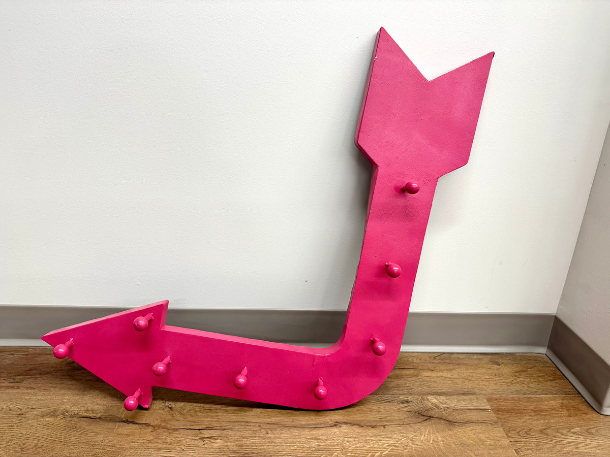 Colgador de pared de metal rosa con forma de flecha
